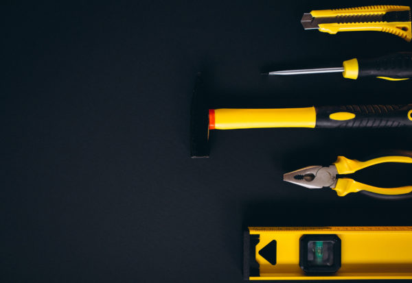 Yellow set of tools on black background Yellow set of tools on black background